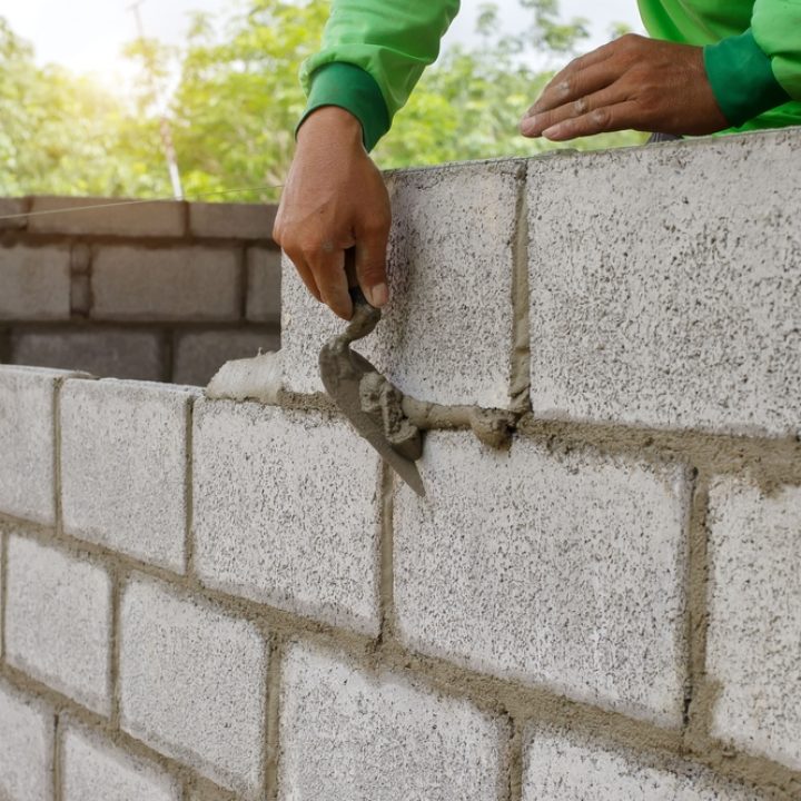 man plastering bricks